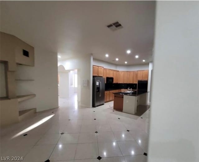 kitchen with sink, light tile patterned floors, and stainless steel fridge with ice dispenser