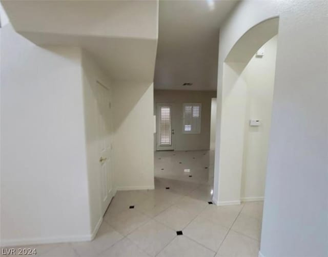 corridor with light tile patterned flooring