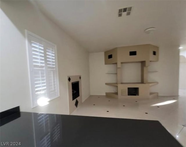 unfurnished living room featuring light tile patterned floors