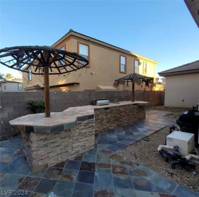 view of patio / terrace featuring area for grilling and exterior bar