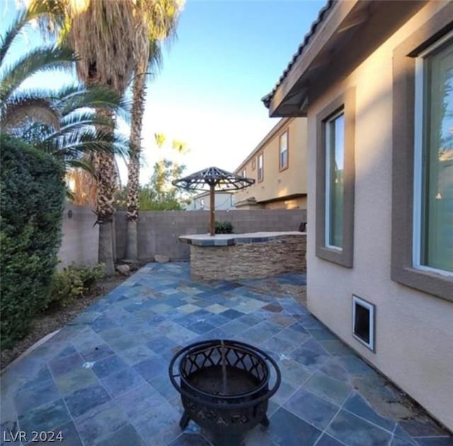 view of patio / terrace featuring an outdoor fire pit