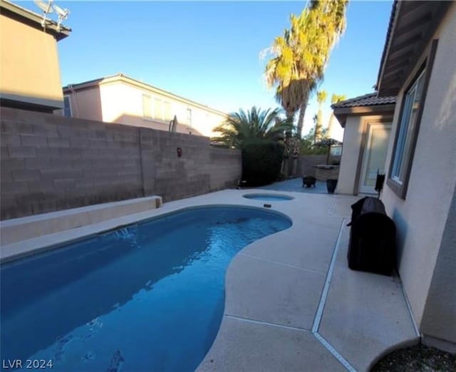 view of swimming pool featuring a patio area