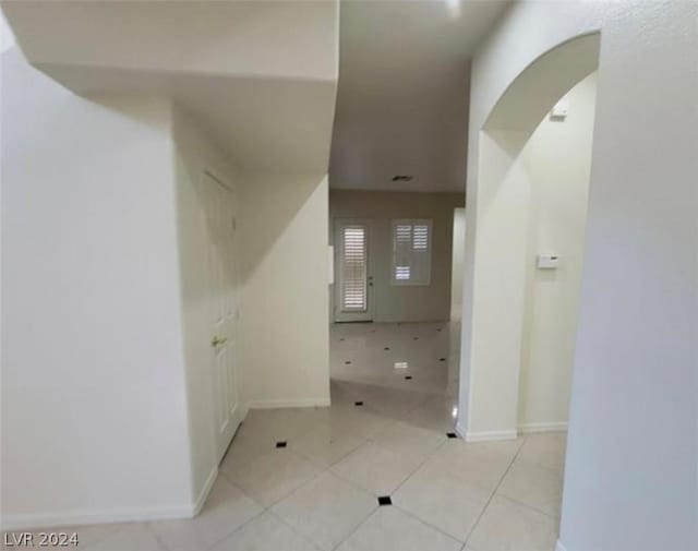 hallway with light tile patterned flooring