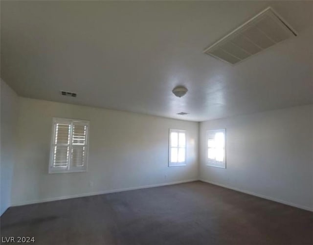 empty room with dark colored carpet