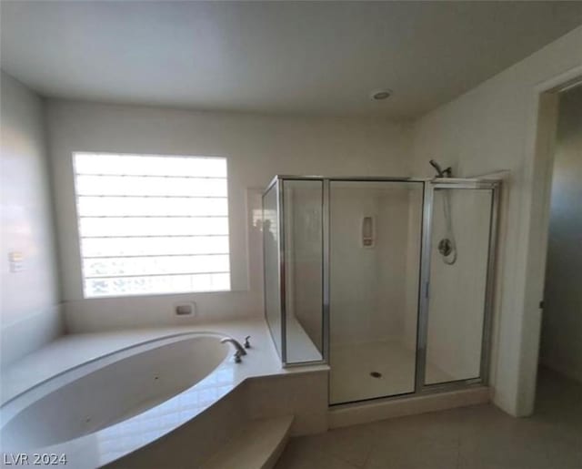 bathroom with tile patterned flooring and separate shower and tub