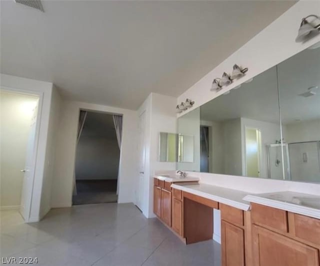 bathroom with vanity, an enclosed shower, and tile patterned floors