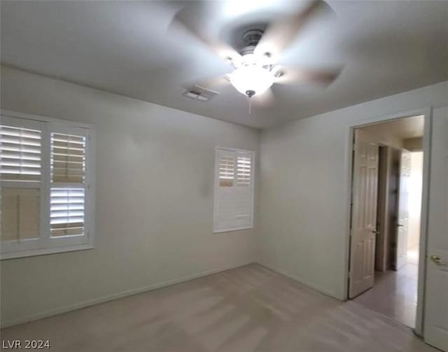 unfurnished room with ceiling fan