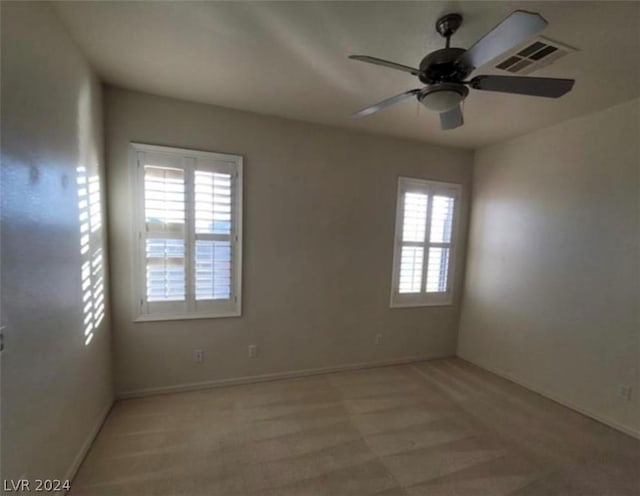 spare room with ceiling fan and a healthy amount of sunlight