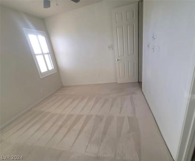 spare room with light carpet and ceiling fan