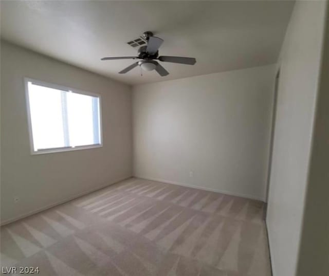 carpeted empty room featuring ceiling fan