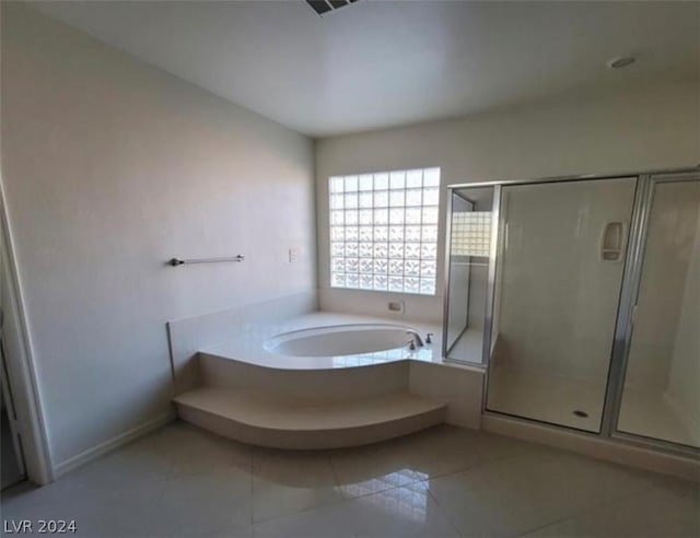 bathroom with tile patterned flooring and independent shower and bath