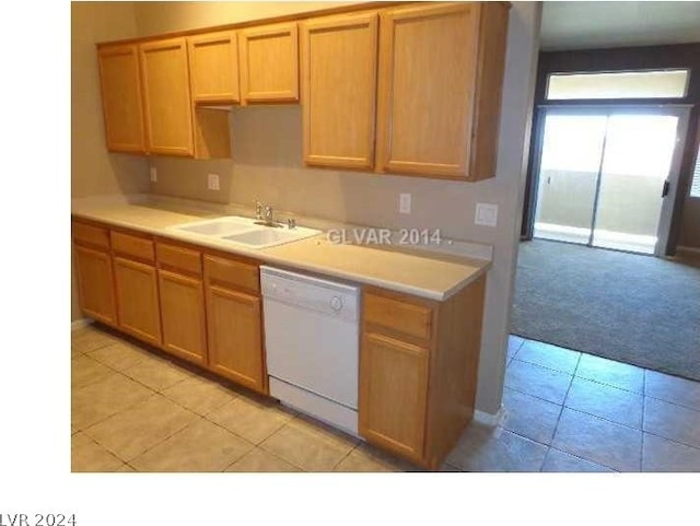 kitchen featuring dishwasher, a sink, light countertops, light tile patterned flooring, and light carpet