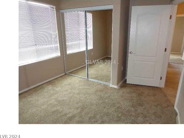 unfurnished bedroom with carpet flooring and a closet