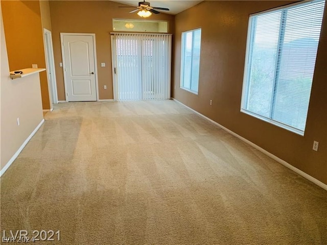 carpeted empty room with ceiling fan