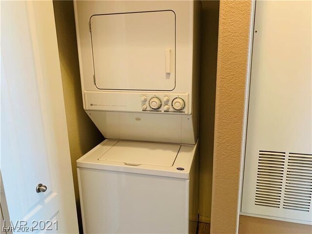 washroom featuring stacked washer and dryer