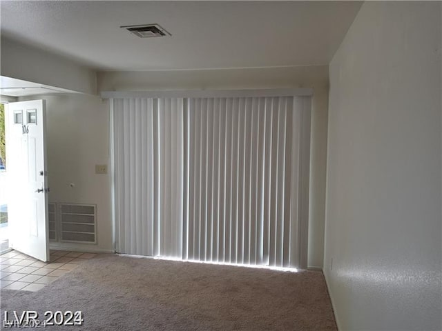 unfurnished room with light carpet