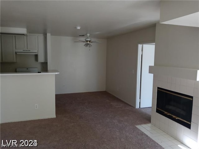 unfurnished living room featuring ceiling fan, light carpet, and a fireplace