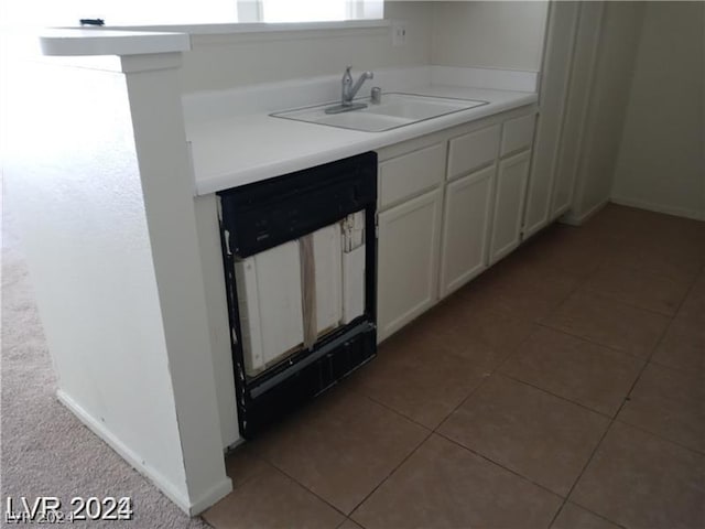 kitchen featuring white cabinetry, sink, tile patterned flooring, and dishwasher