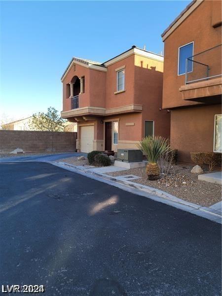 view of front of home with a garage and a balcony