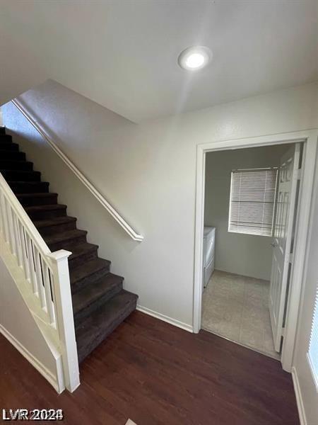 stairs featuring hardwood / wood-style floors