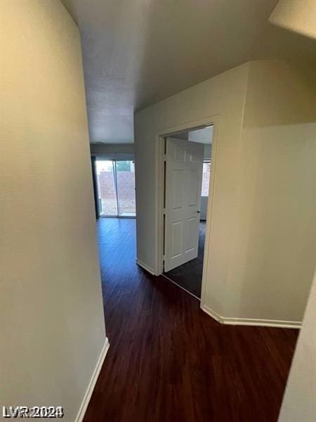 corridor featuring dark wood-type flooring