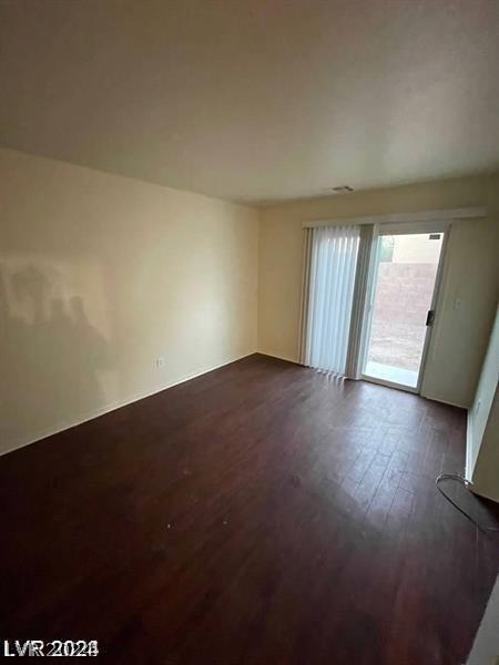 spare room with dark hardwood / wood-style floors