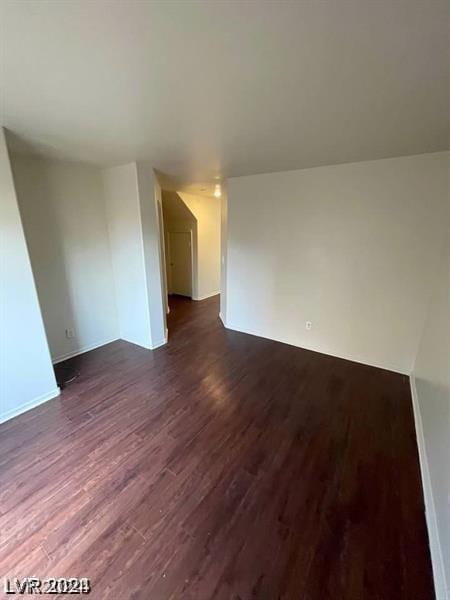 spare room with dark wood-type flooring