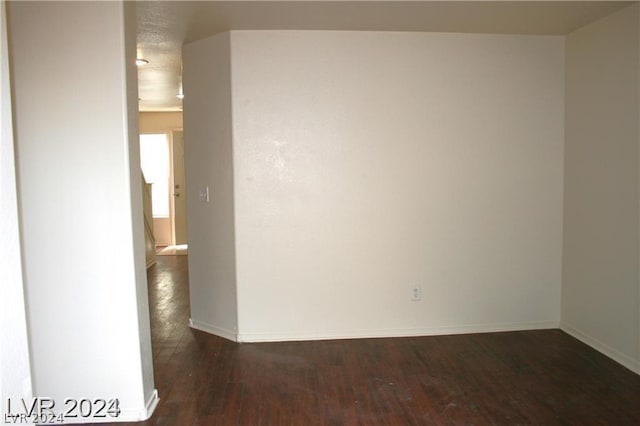 unfurnished room featuring dark hardwood / wood-style flooring