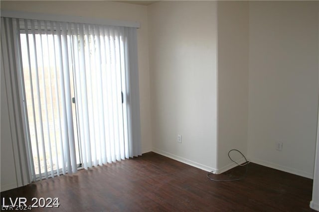 unfurnished room with dark hardwood / wood-style floors