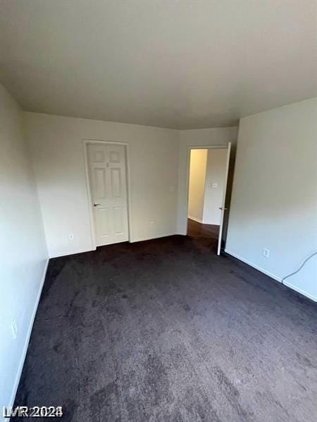 empty room with dark carpet