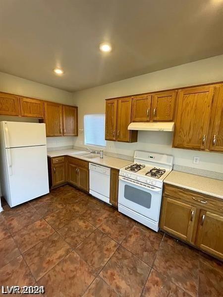 kitchen featuring white appliances and sink