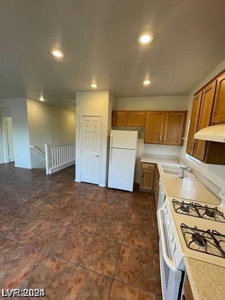 kitchen with white appliances and sink