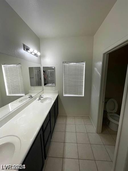 bathroom featuring tile patterned flooring, vanity, and toilet