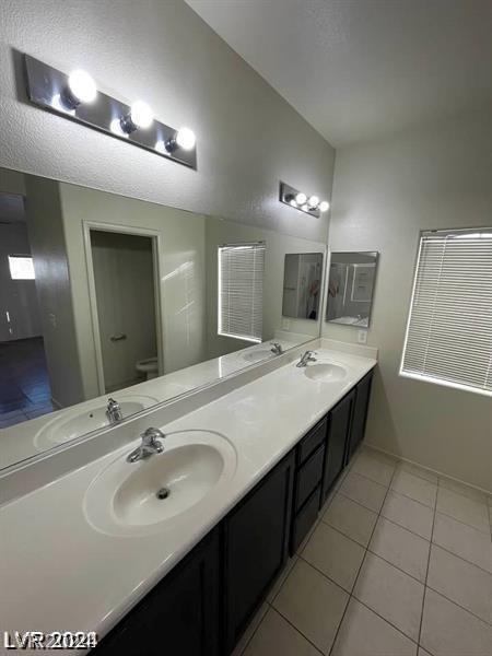 bathroom with vanity, tile patterned floors, and toilet