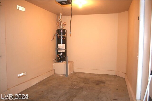 garage with a garage door opener and strapped water heater