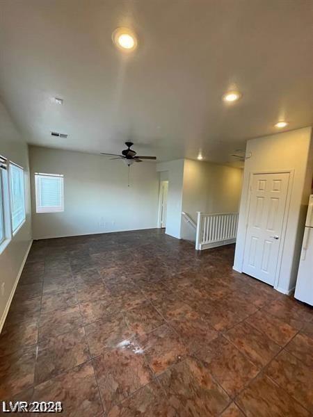 unfurnished room with ceiling fan