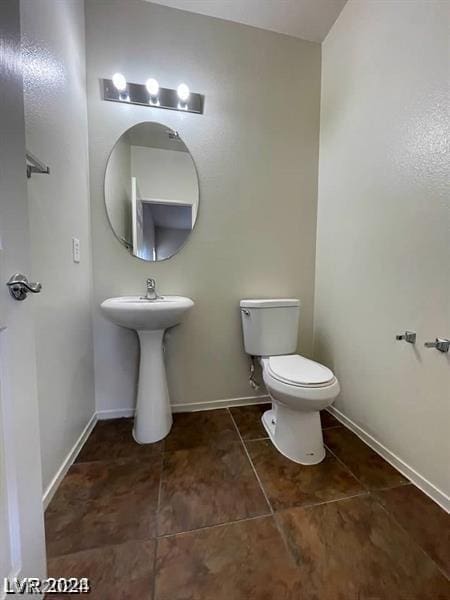 bathroom with tile patterned flooring and toilet