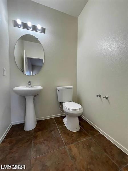 bathroom featuring tile patterned flooring and toilet