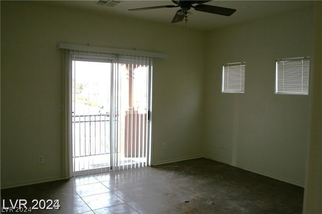 unfurnished room featuring ceiling fan, tile patterned floors, and plenty of natural light