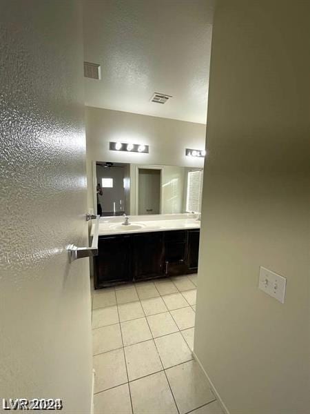 bathroom featuring tile patterned flooring and vanity