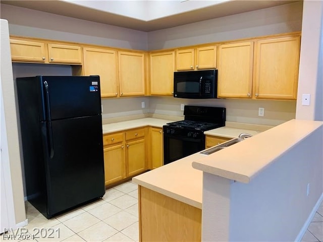 kitchen with light tile floors, black appliances, kitchen peninsula, sink, and light brown cabinetry