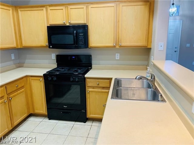 kitchen featuring hanging light fixtures, sink, black appliances, and light tile floors