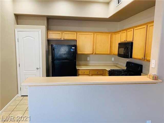 kitchen featuring light brown cabinets, black appliances, light tile floors, and kitchen peninsula