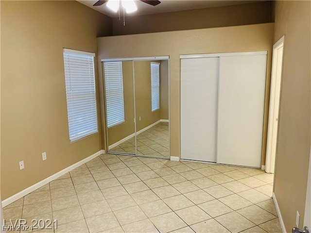 unfurnished bedroom featuring ceiling fan and light tile floors