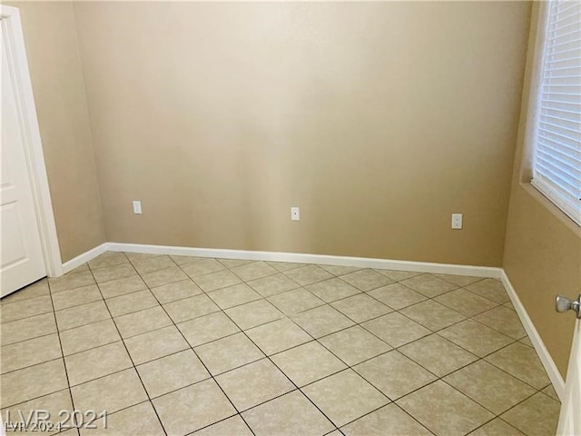 spare room with light tile floors