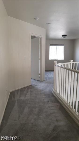 corridor with dark colored carpet