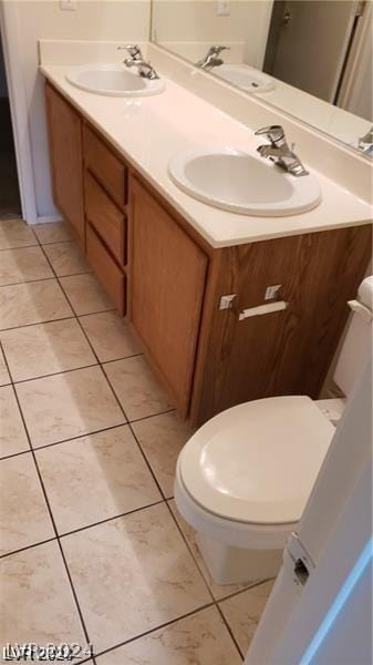 bathroom featuring vanity, tile patterned floors, and toilet