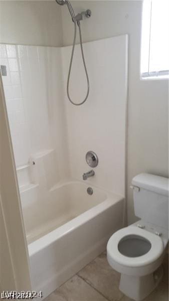 bathroom featuring tile patterned floors, toilet, and bathing tub / shower combination