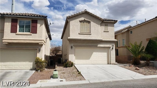 view of front of house with central AC and a garage