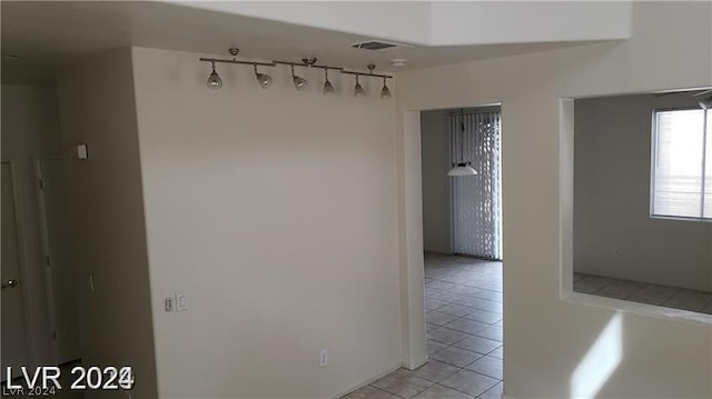 hallway with light tile patterned floors